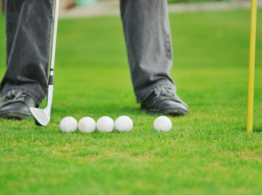 Players enjoying indoor golf and mini golf games at Birdie Indoor Golf Club in Burnaby and Richmond, featuring digital golf screen setups and coach training areas